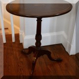 F21. Small tilt top banded mahogany side table. 24”h x 19”w x 14”d 